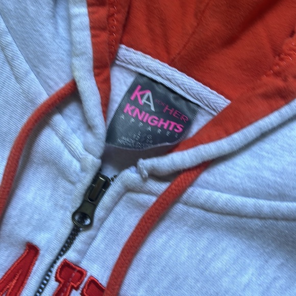 This is an orange and grey zip up hoodie that has never been worn. - Picture 2 of 4